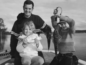 Andrew Munro and his daughters Ella, 5, and Bree, 7, with a couple of flatties and snapper destined for the dinner table.